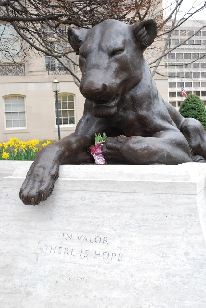 a bronze statue of a lioness