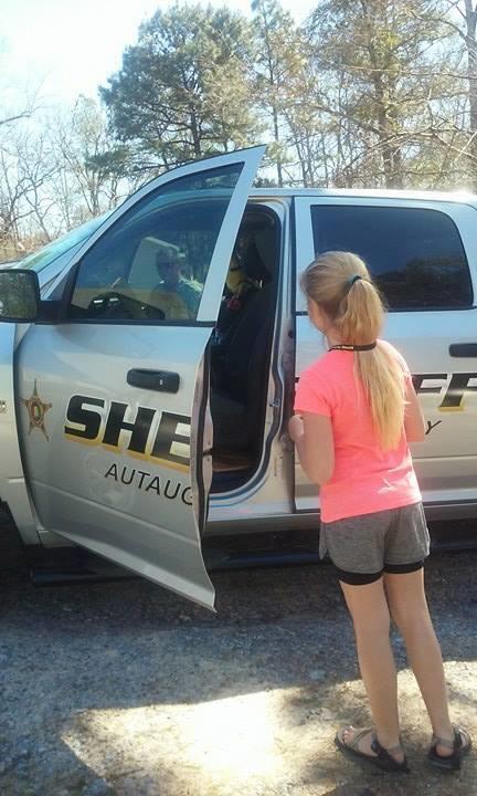 Girl Looking at Patrol Vehicle