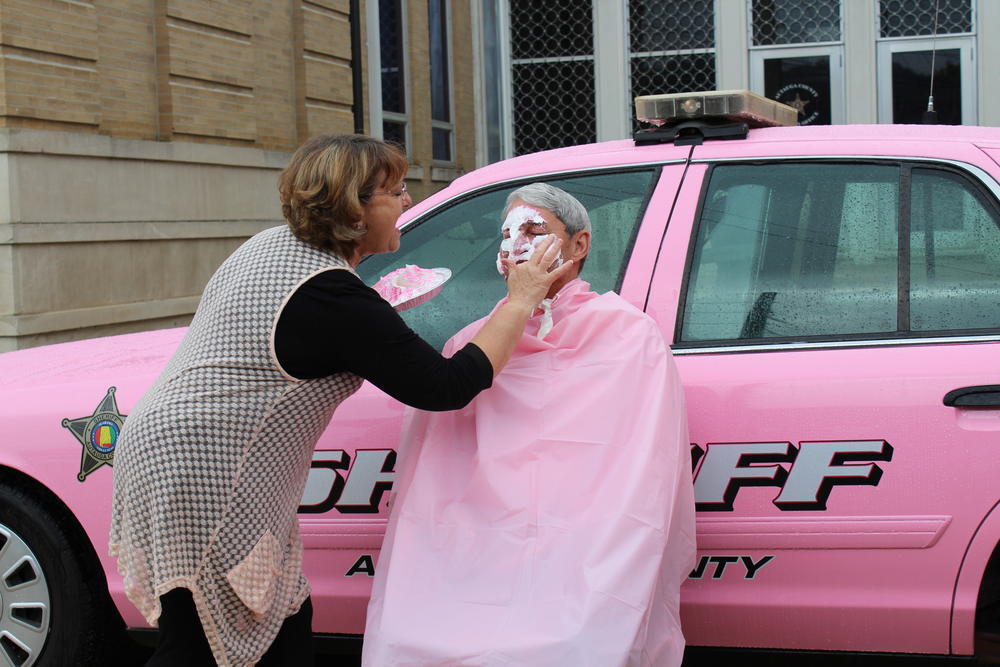 Leona Sedinger putting whip cream on Sheriff Sedinger's face