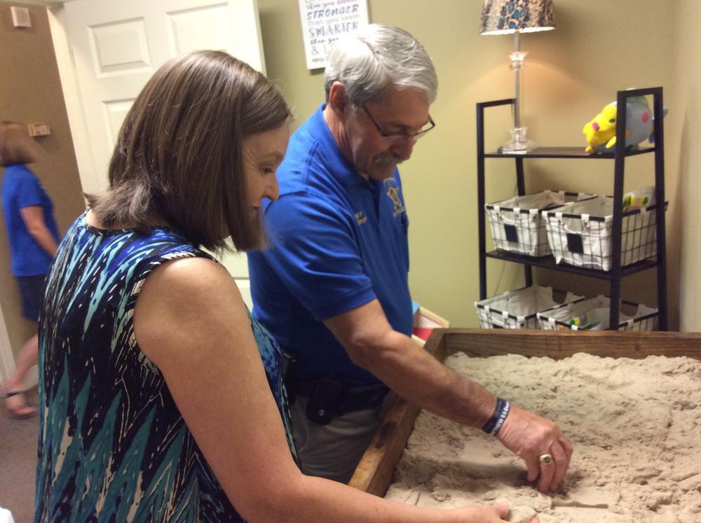 Sheriff and Circuit Clerk playing in sand