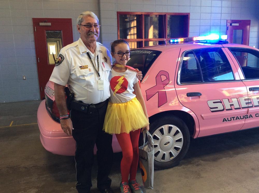 Sheriff Sedinger posing for a photo with Pink Car