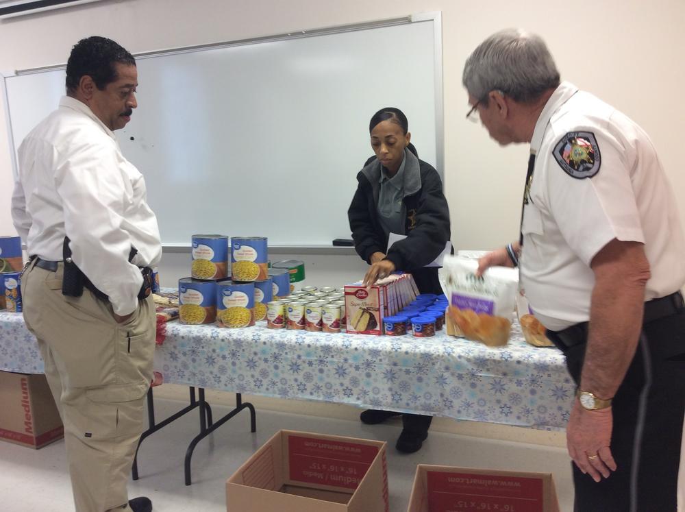 Lt. Slater, Ngozi Slater & Sheriff Sedinger packing boxes